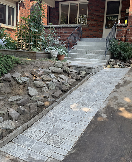 front yard pathway covered with interlock