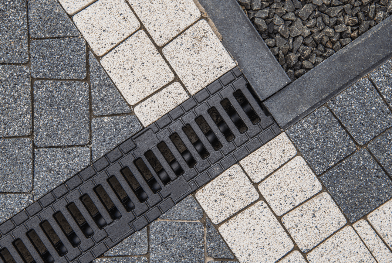 Landscape drainage system in interlocking backyard