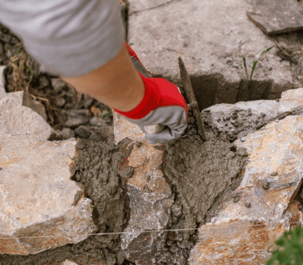 A worker repairing natural stone surface